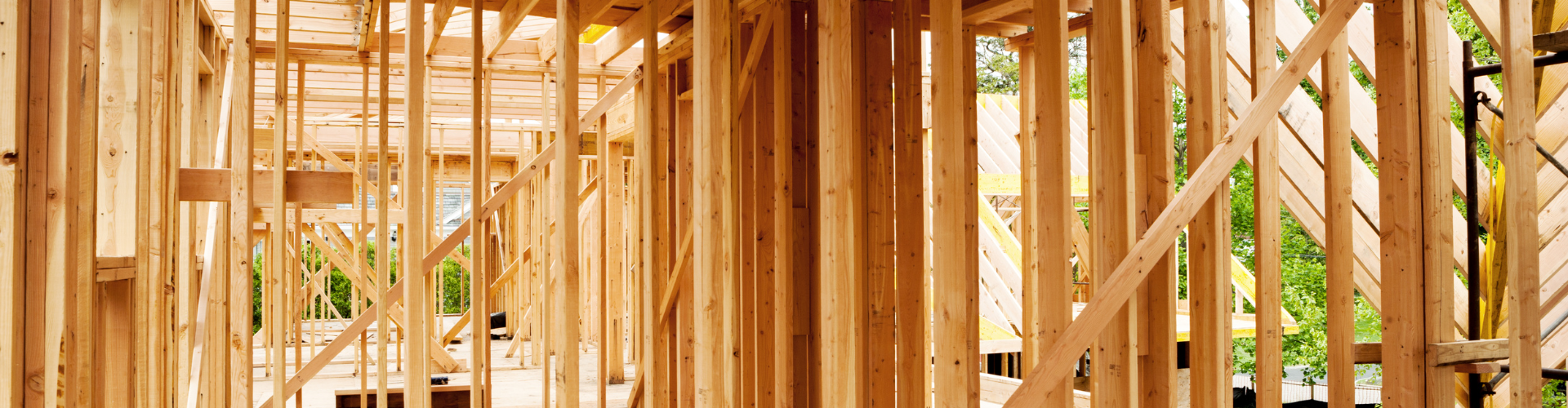 A wooden fence with a green field.