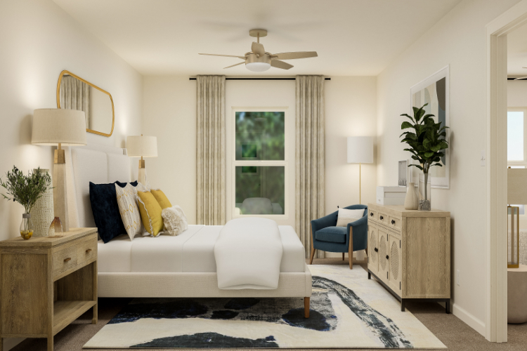 A living room with a white couch and a fan.
