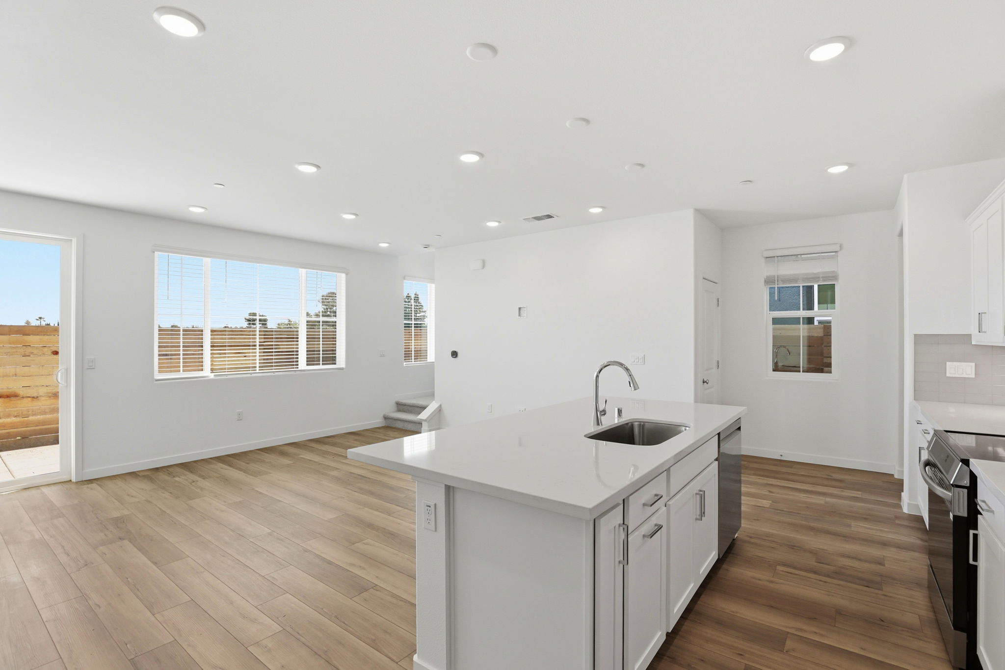 A kitchen with white cabinets.