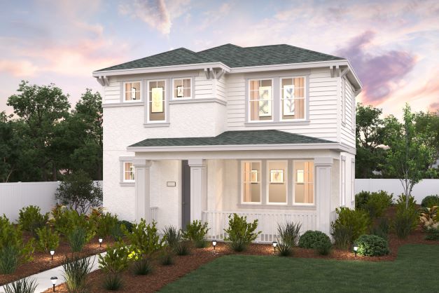 A white house with a green lawn.