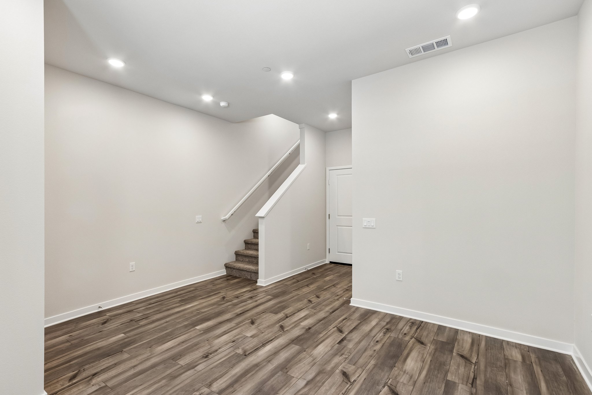 A hallway with white walls.