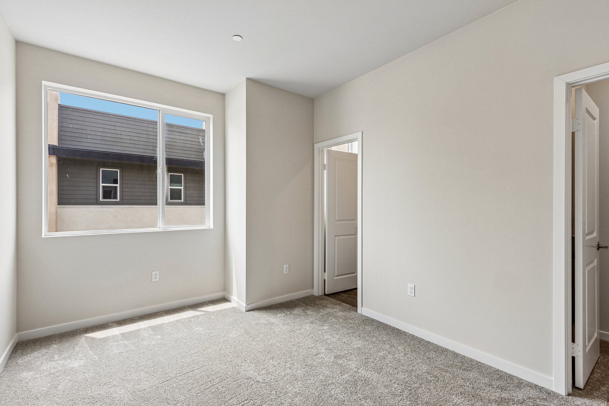 A room with a window and a door.