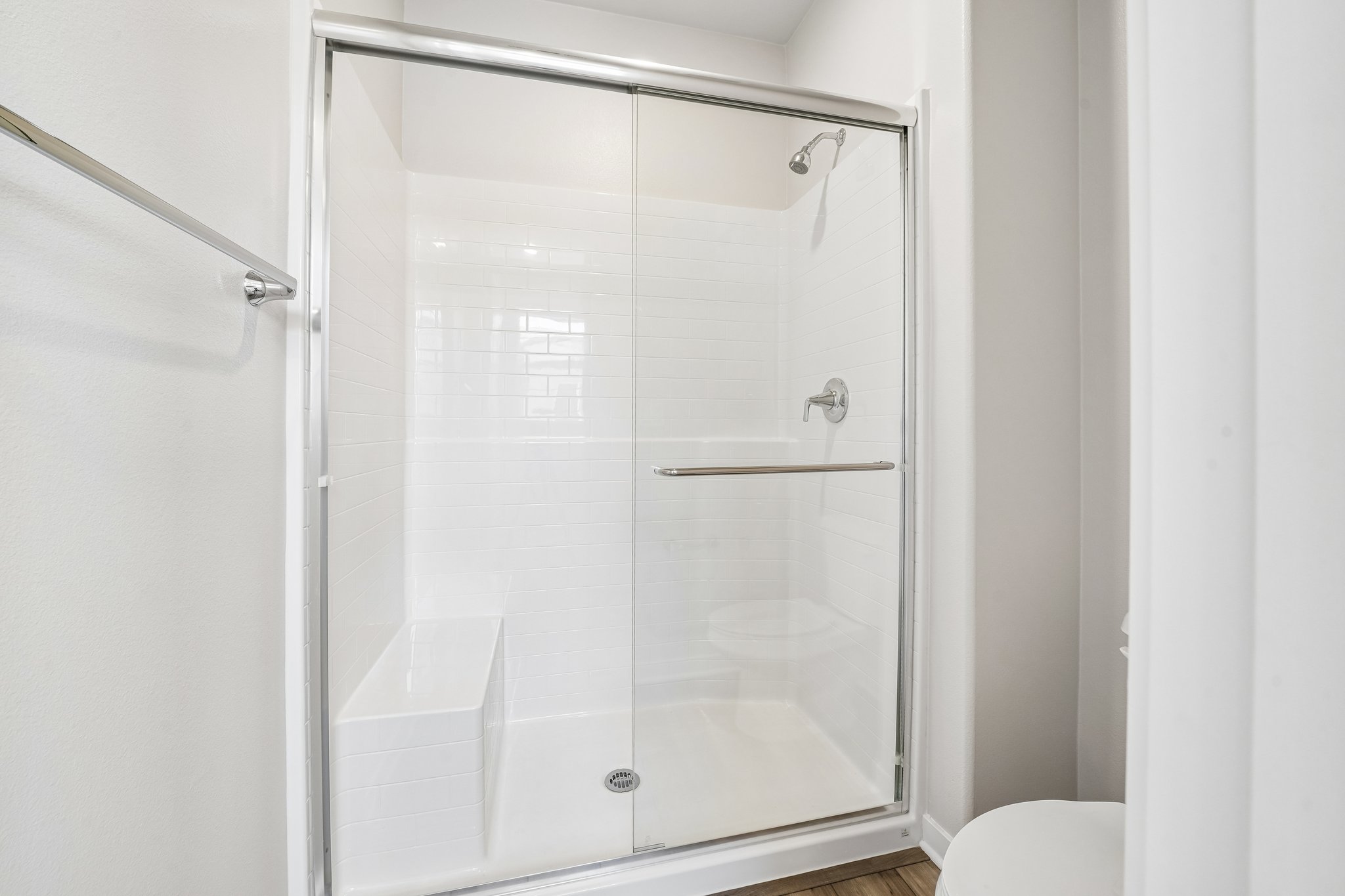 A shower with a glass door.