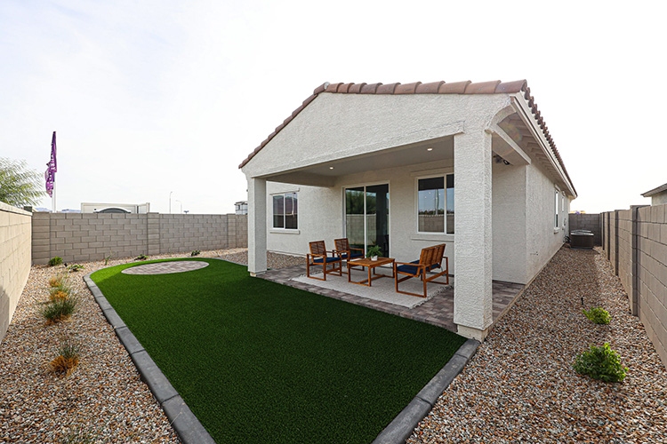 A house with a pool and chairs.