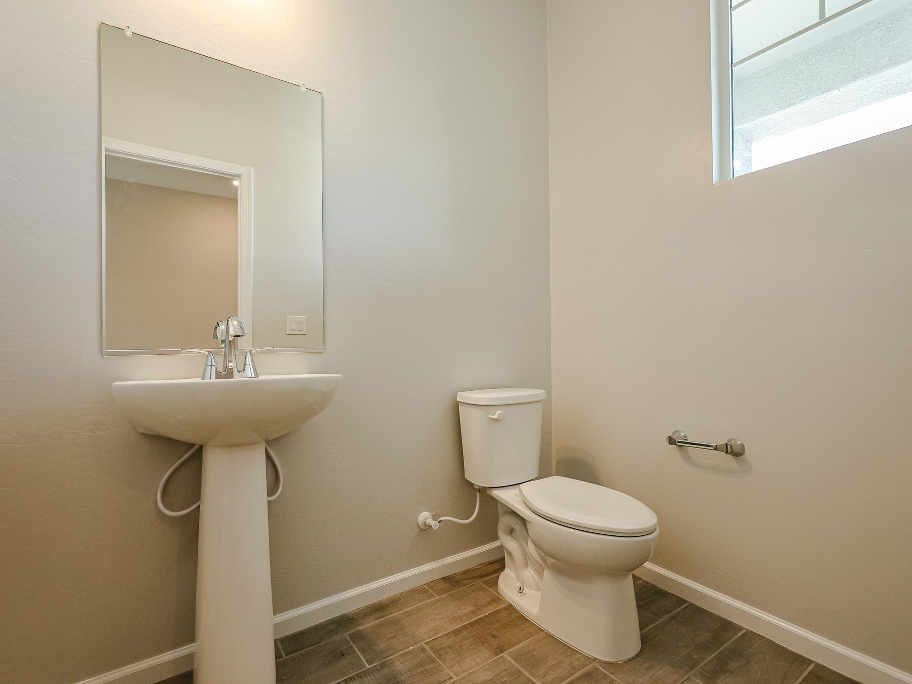 A bathroom with a sink and toilet.