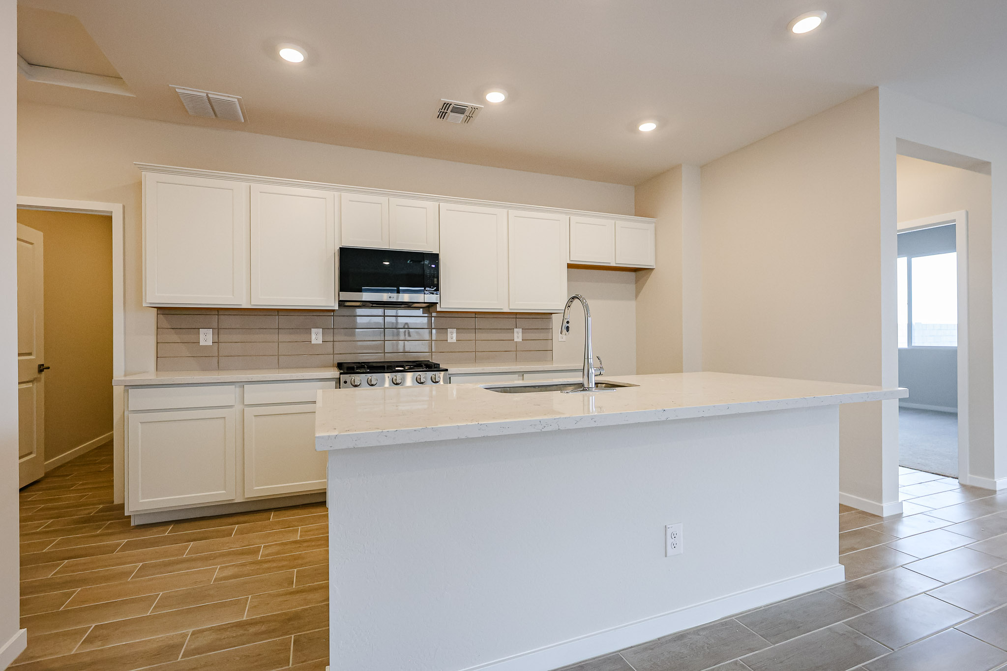 A kitchen with white cabinets.