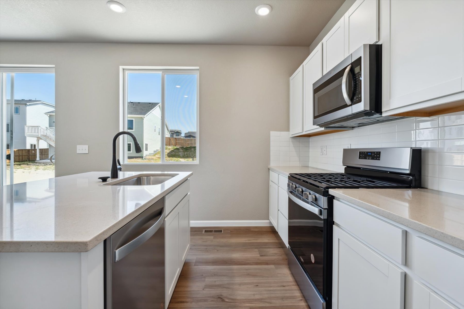 A kitchen with white cabinets.