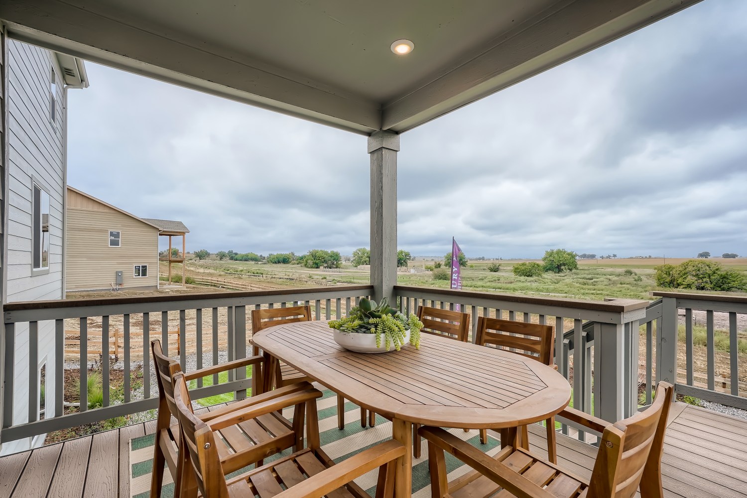 A table and chairs on a deck.