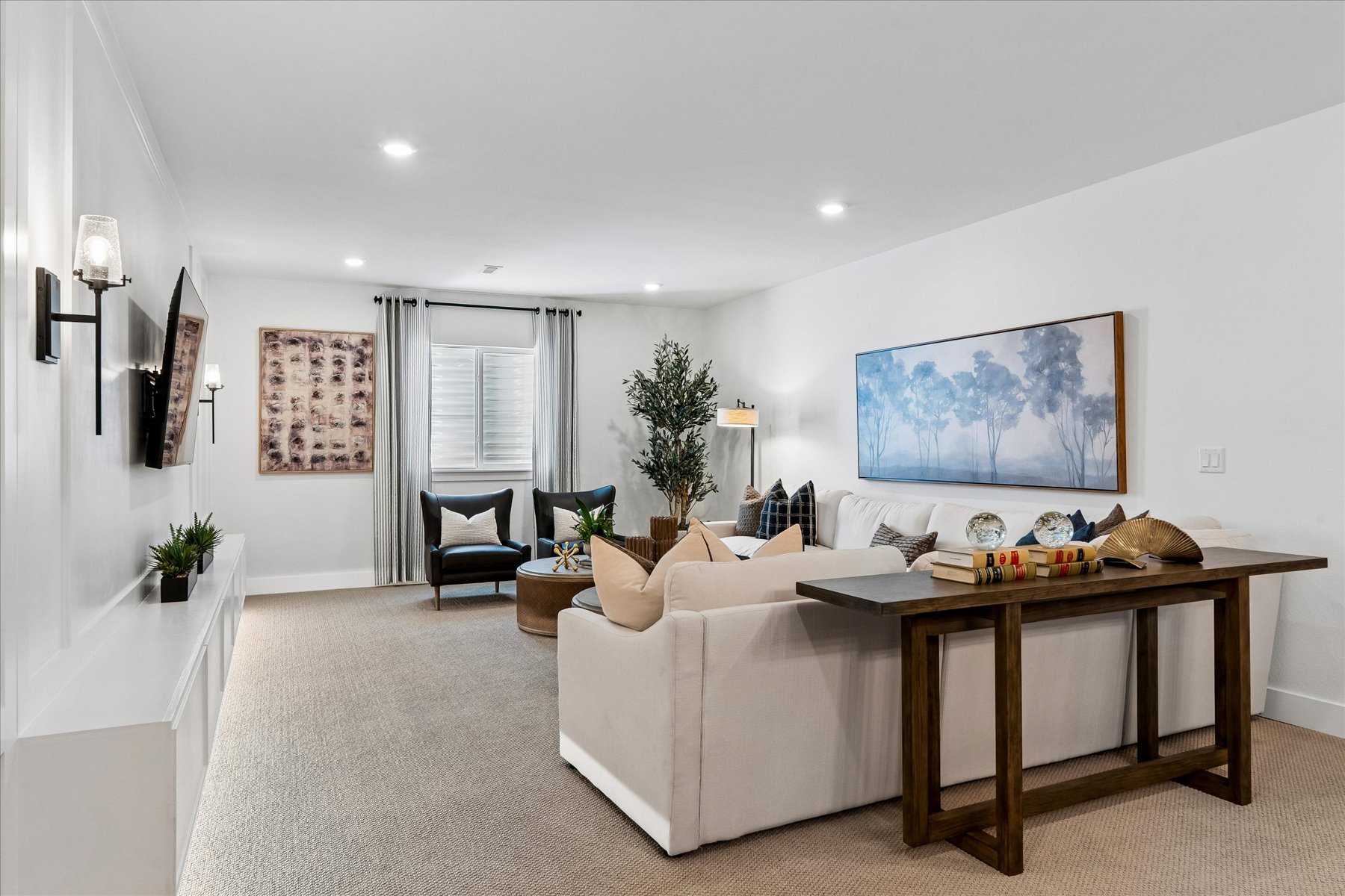 A large living room with a large white couch.