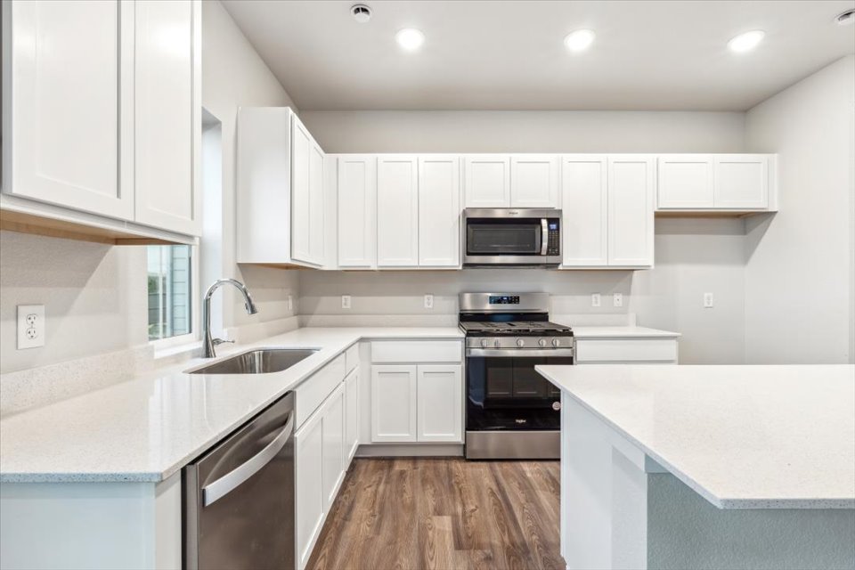 A kitchen with white cabinets.