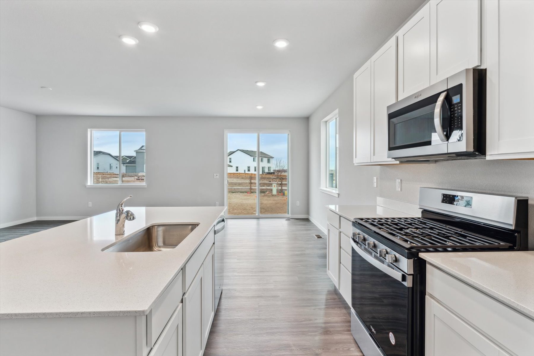 A kitchen with white cabinets.