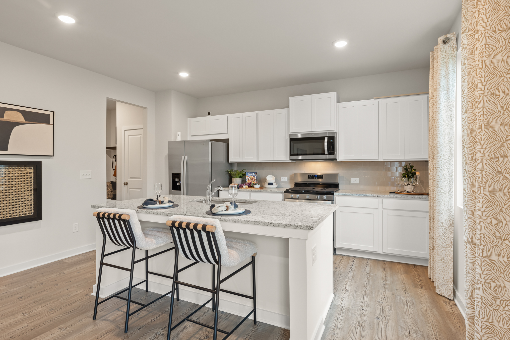 A kitchen with white cabinets.