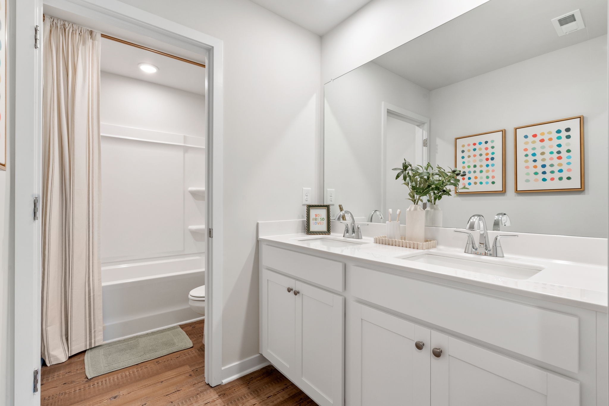 A bathroom with a tub sink and a shower.