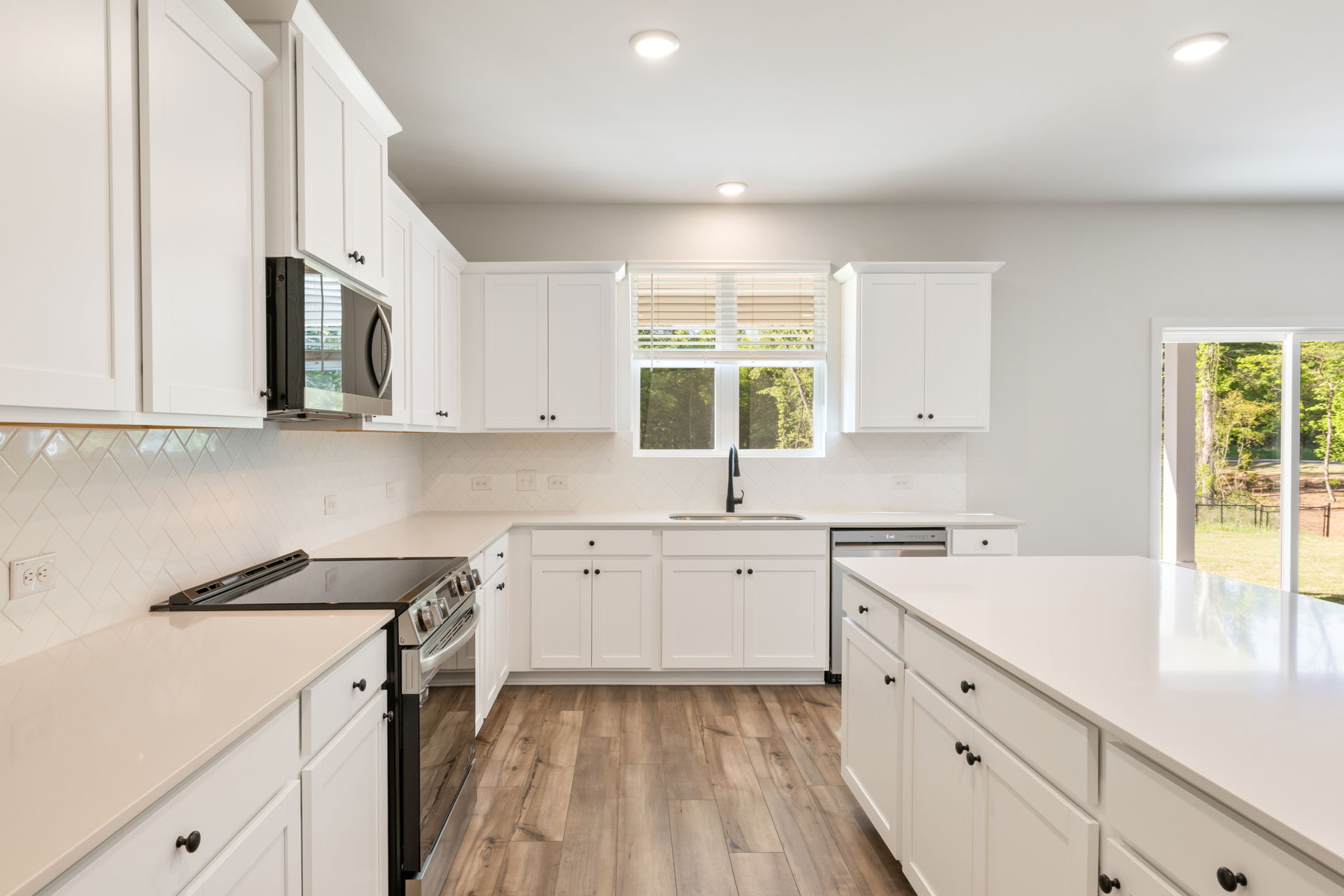 A kitchen with white cabinets.