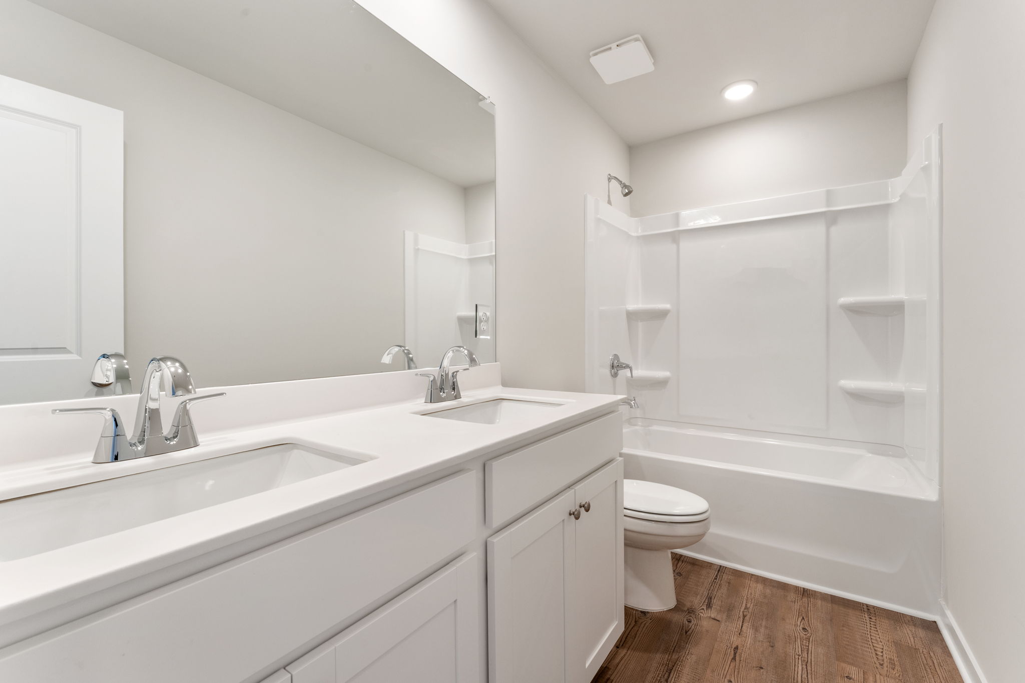 A bathroom with a tub sink and toilet.