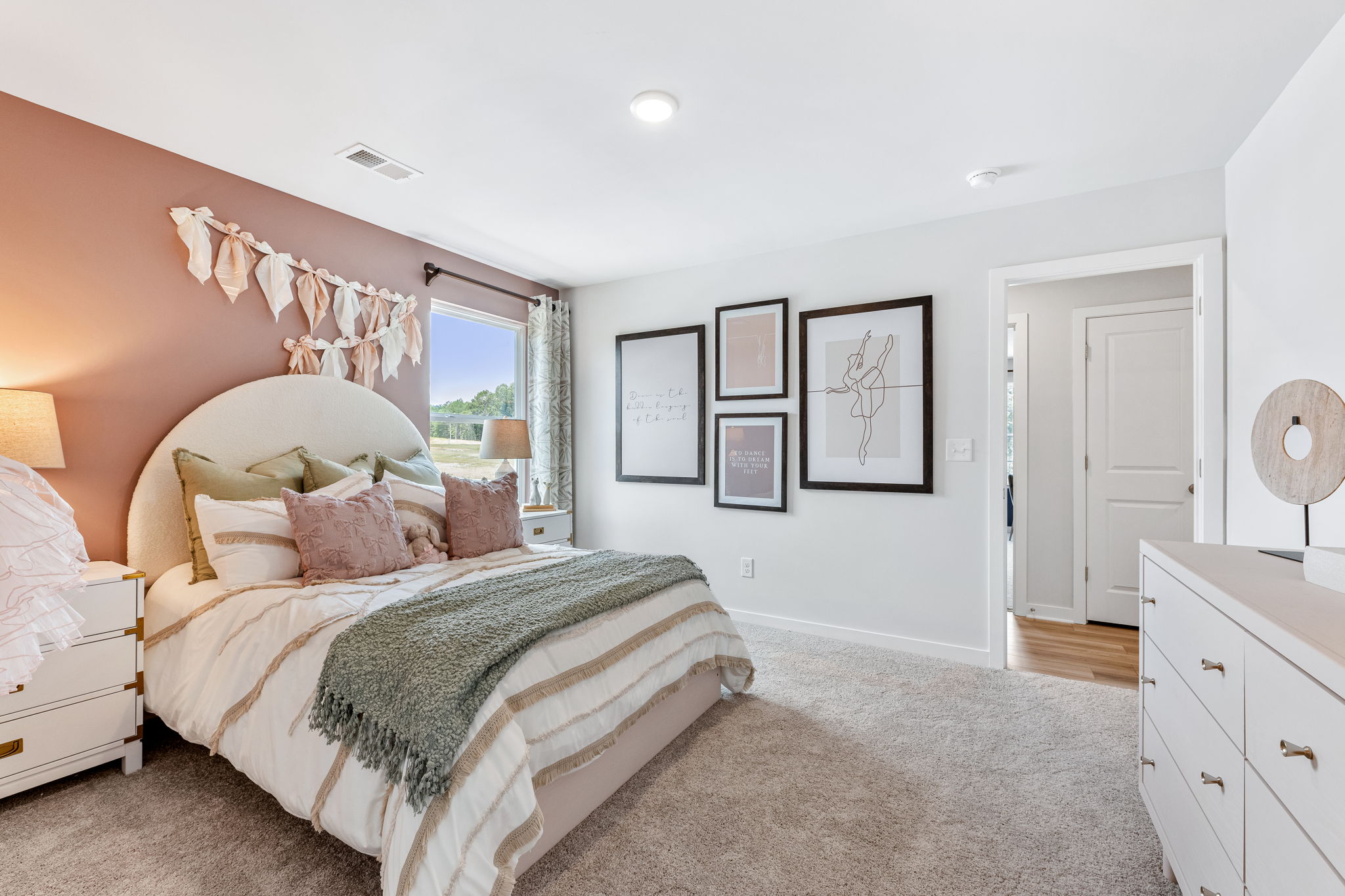 A bedroom with a bed and a fan.