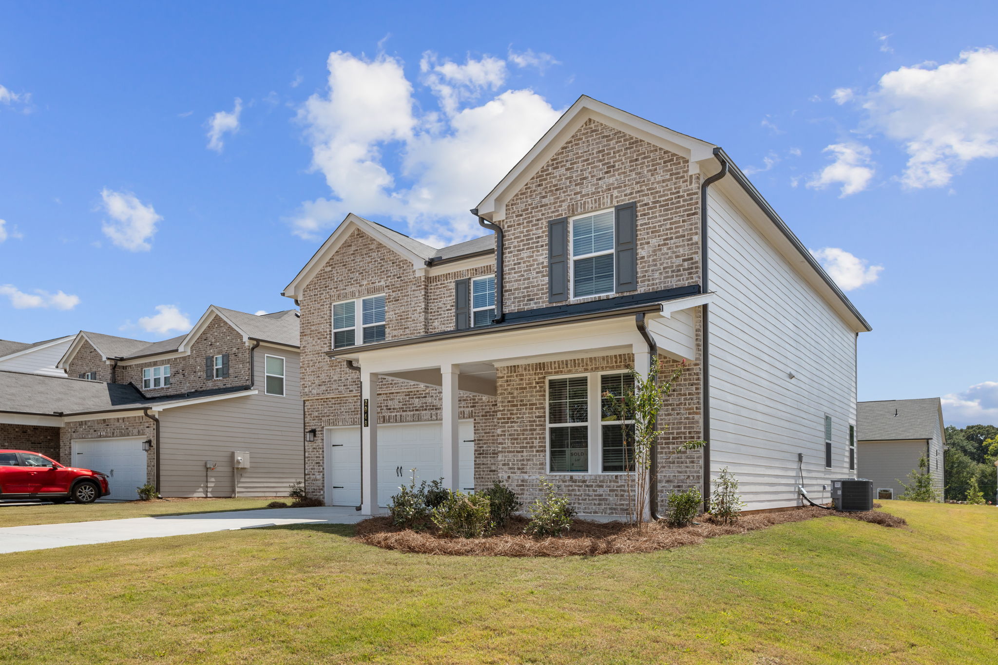 A house with a car parked in the driveway.