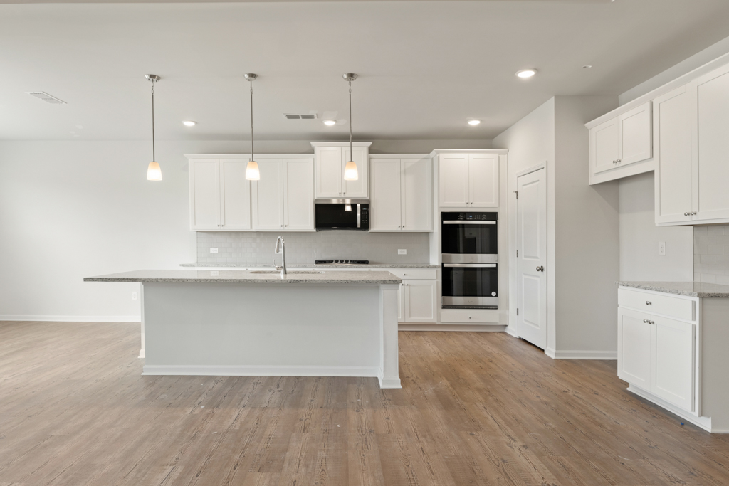 A kitchen with white cabinets.
