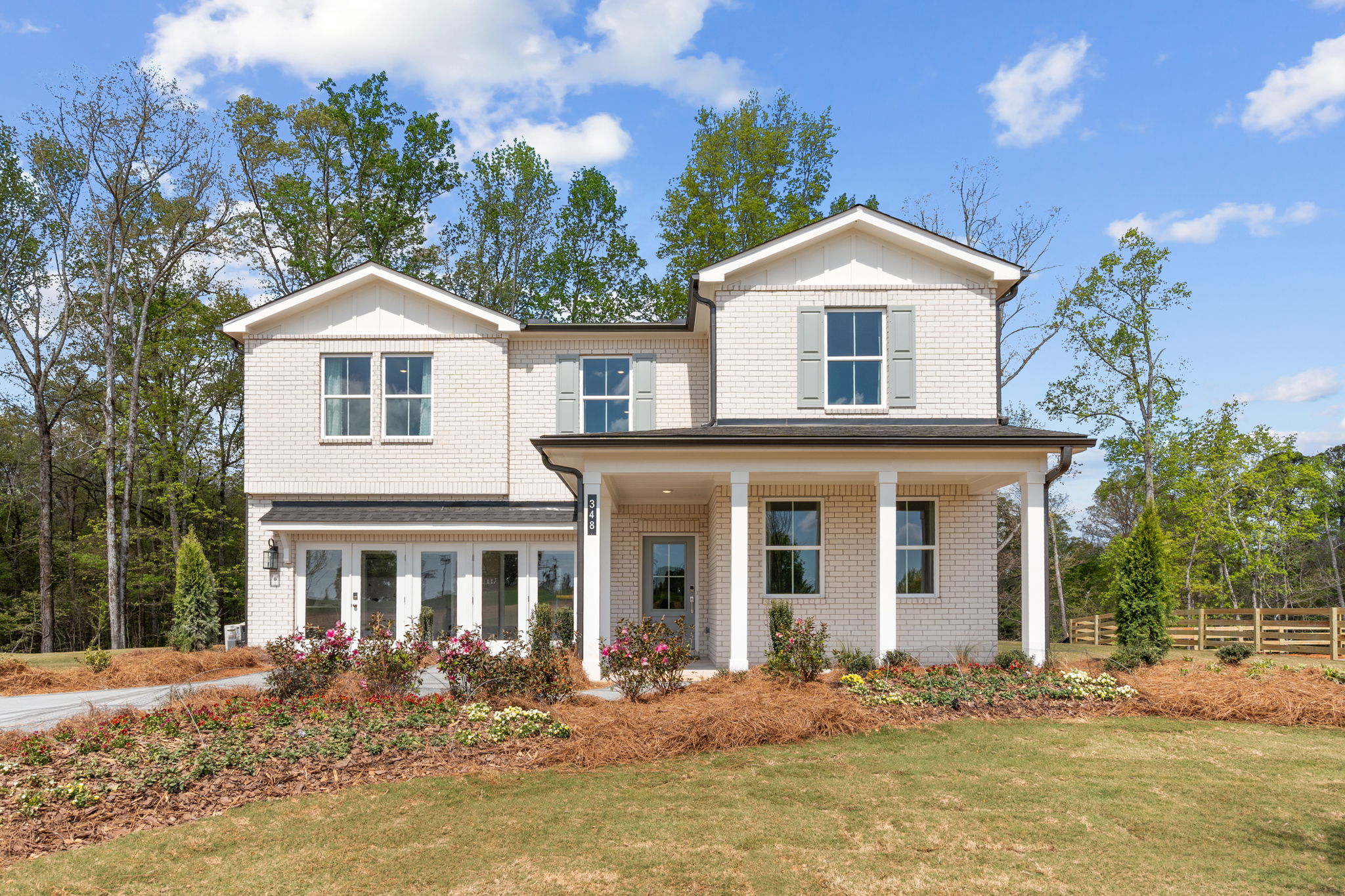 A large house with a large front yard.