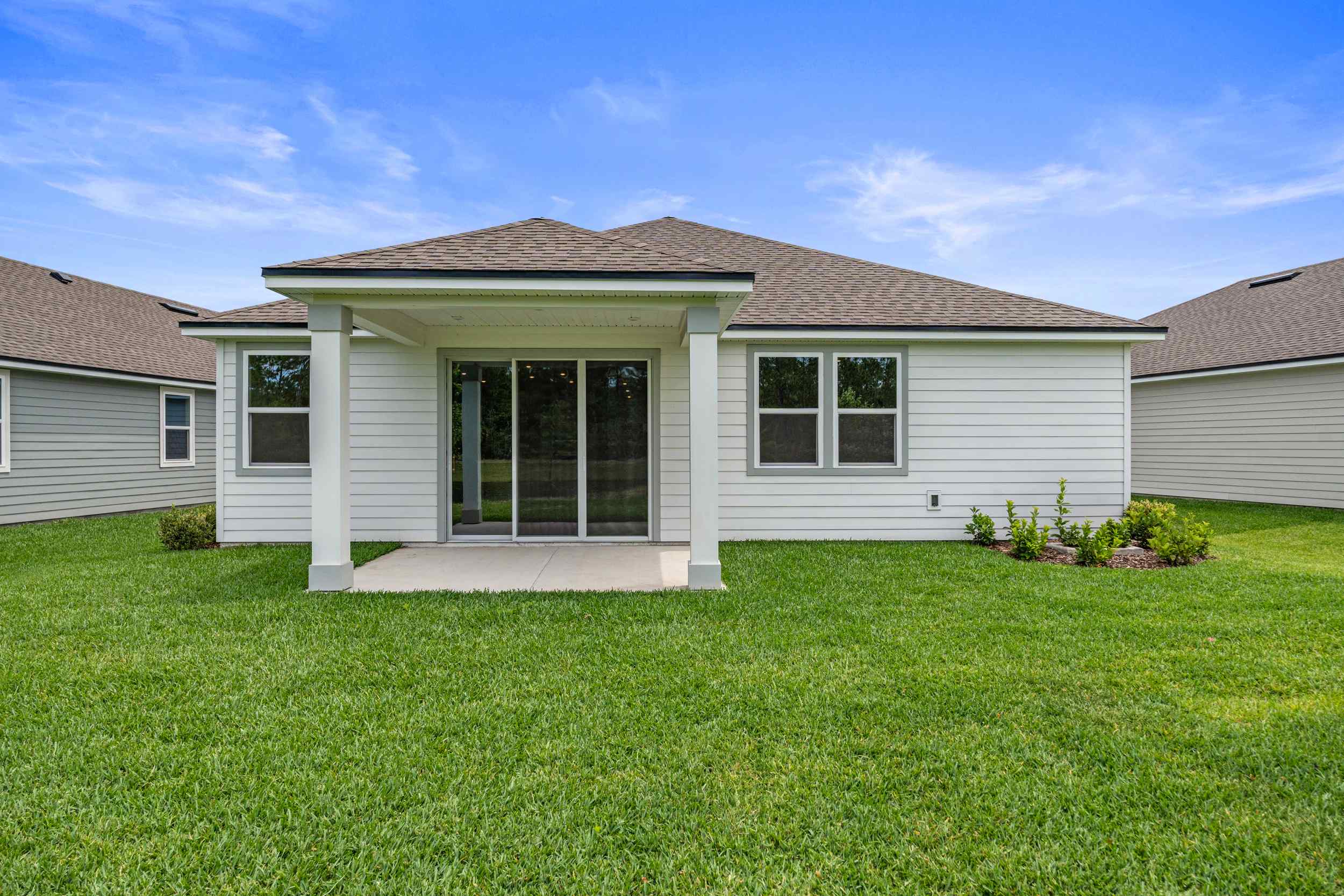 Charleston II Floorplan Lot 50 Backyard with Covered Patio at Seminole Palms in Palm Coast