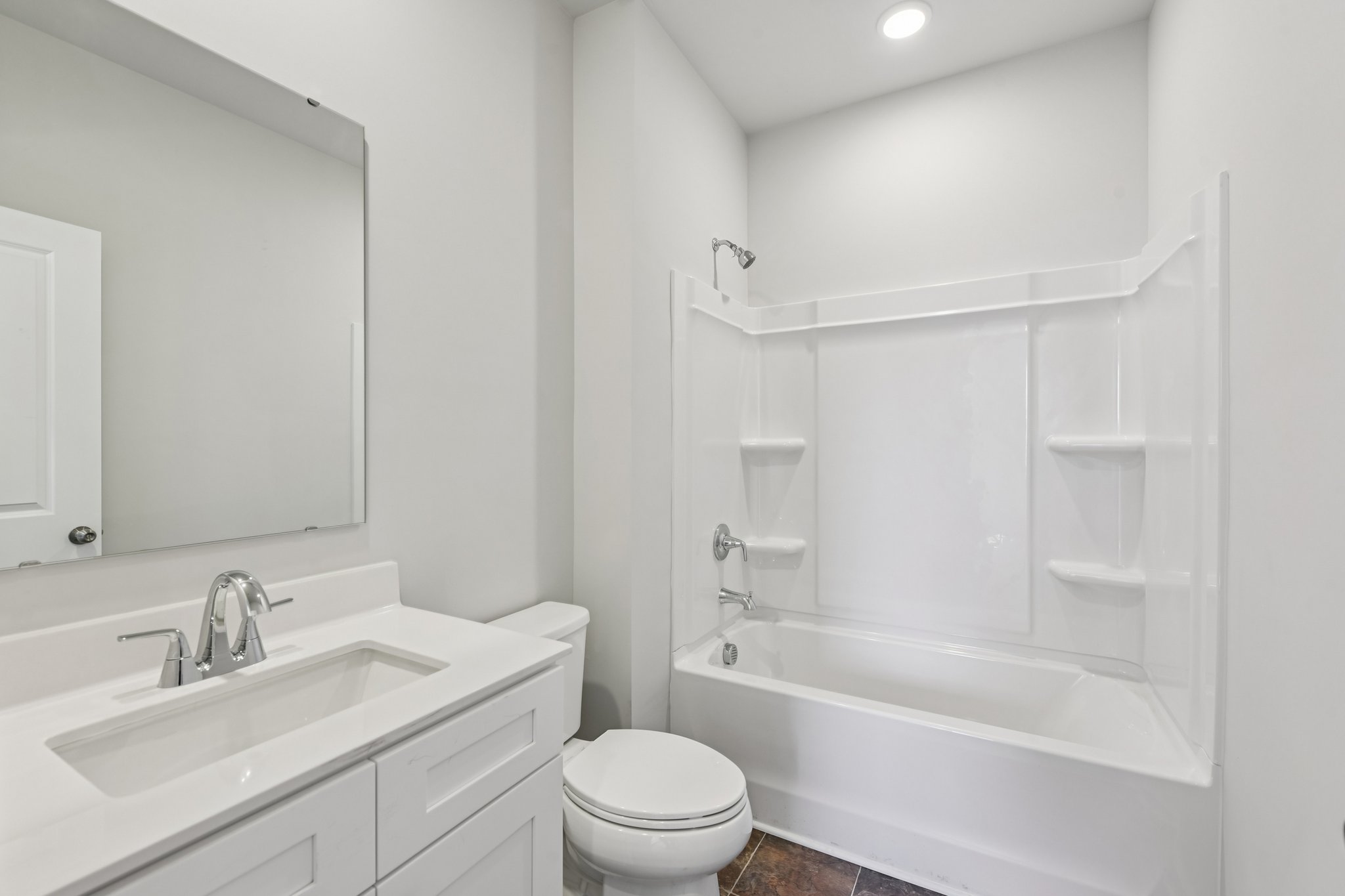 A bathroom with a tub sink and toilet.