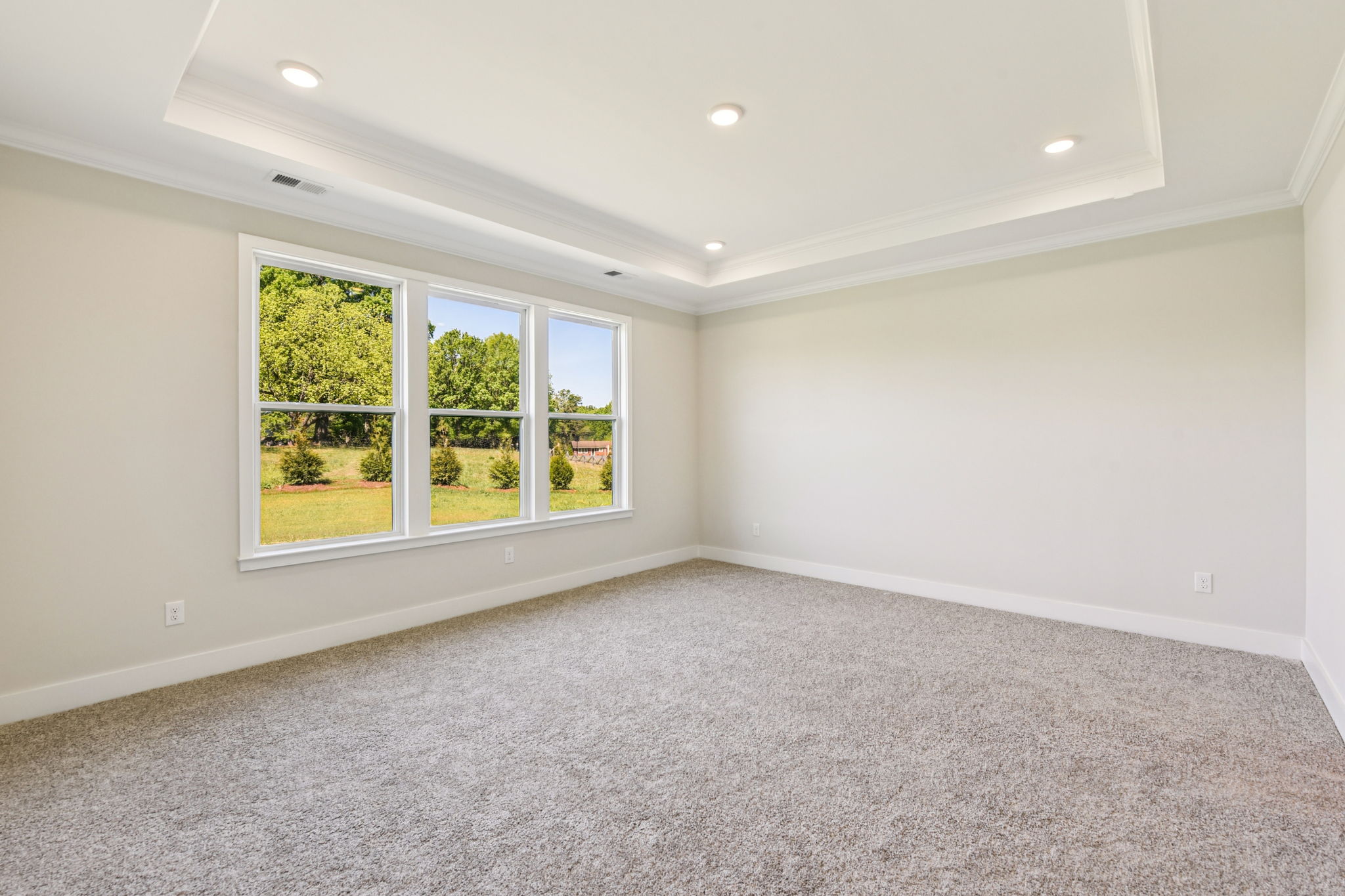 A room with a window and a carpet.