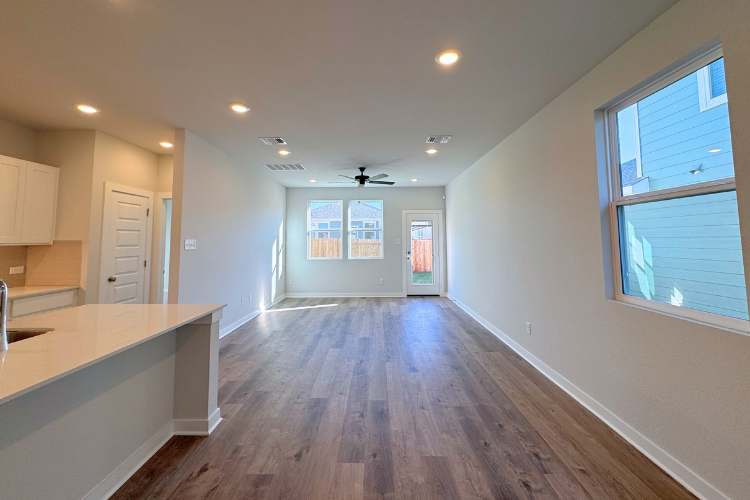 A kitchen with a wood floor.