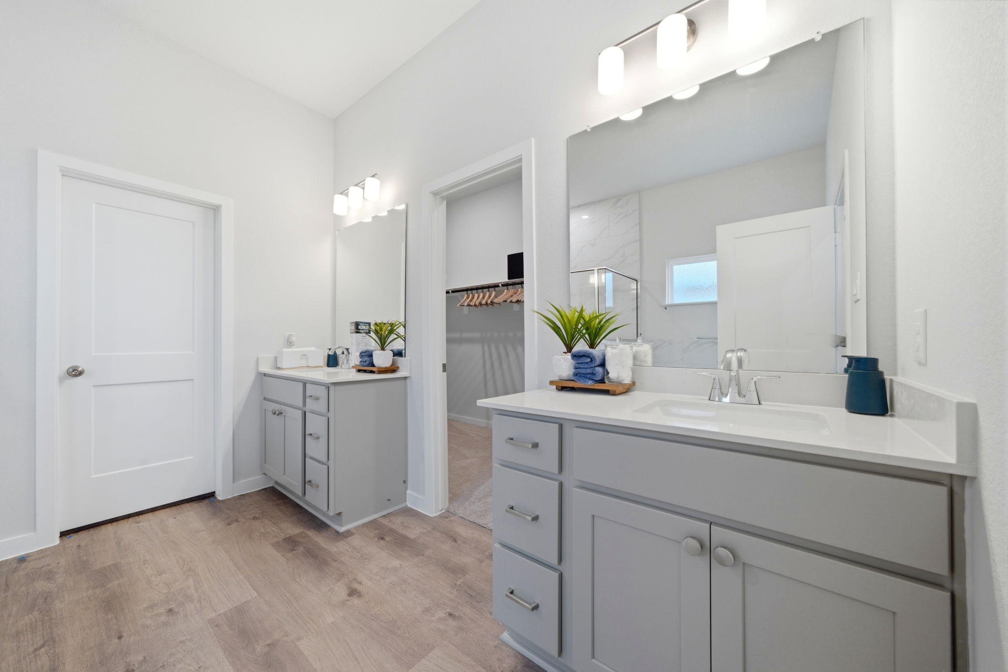 A bathroom with white cabinets.