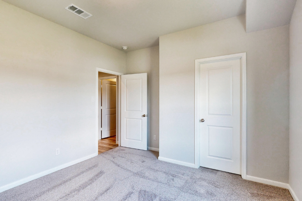 A hallway with white doors.