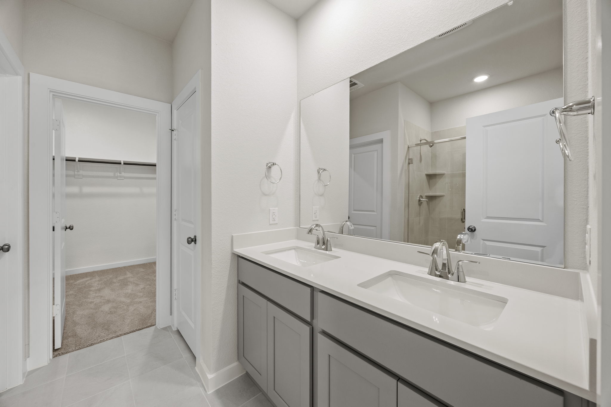A bathroom with a large mirror.