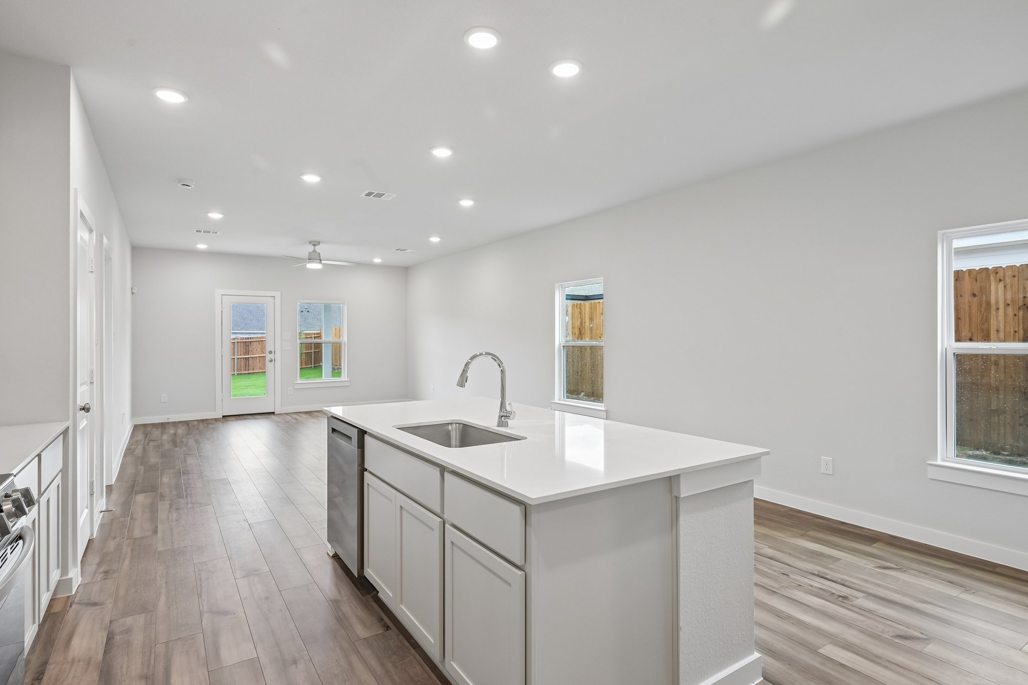 A kitchen with a wood floor.