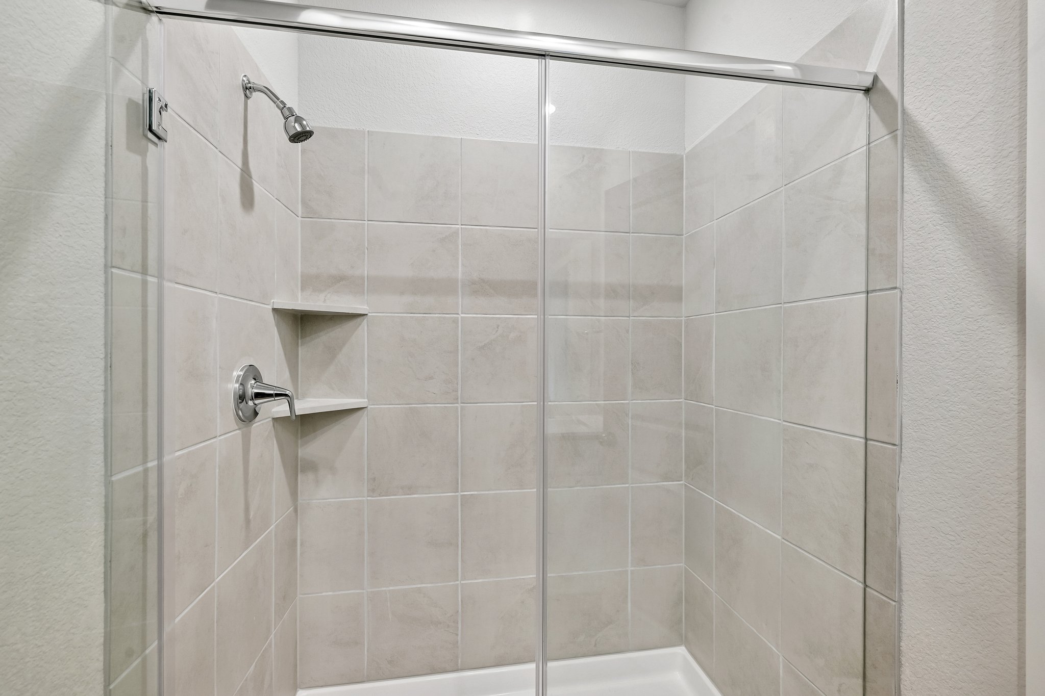 A shower with a glass door.