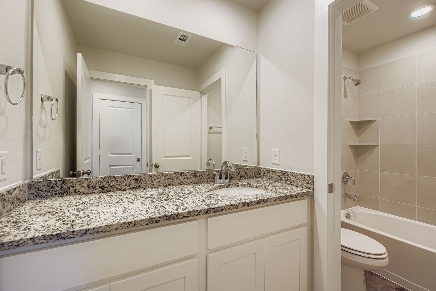 A bathroom with marble countertop.