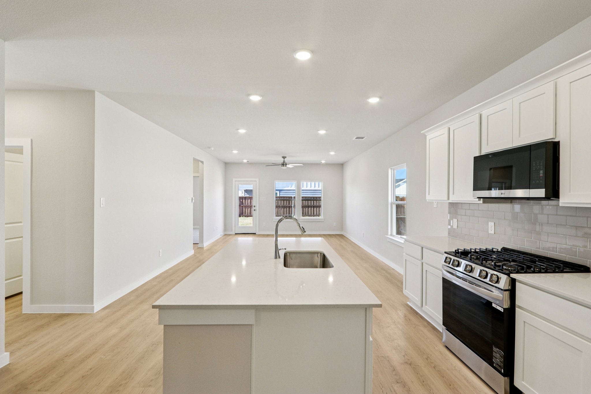 A kitchen with white cabinets.