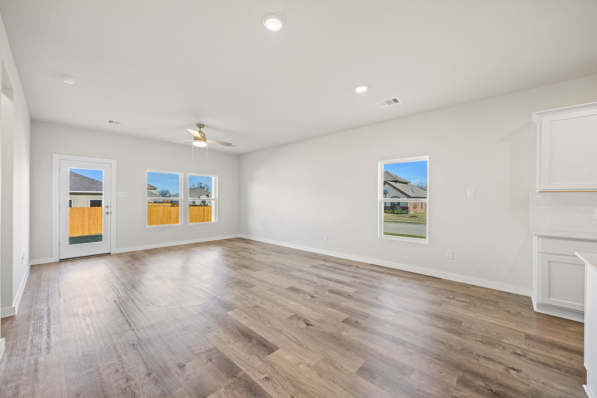 A room with a wood floor and a wood floor with a painting on the wall.