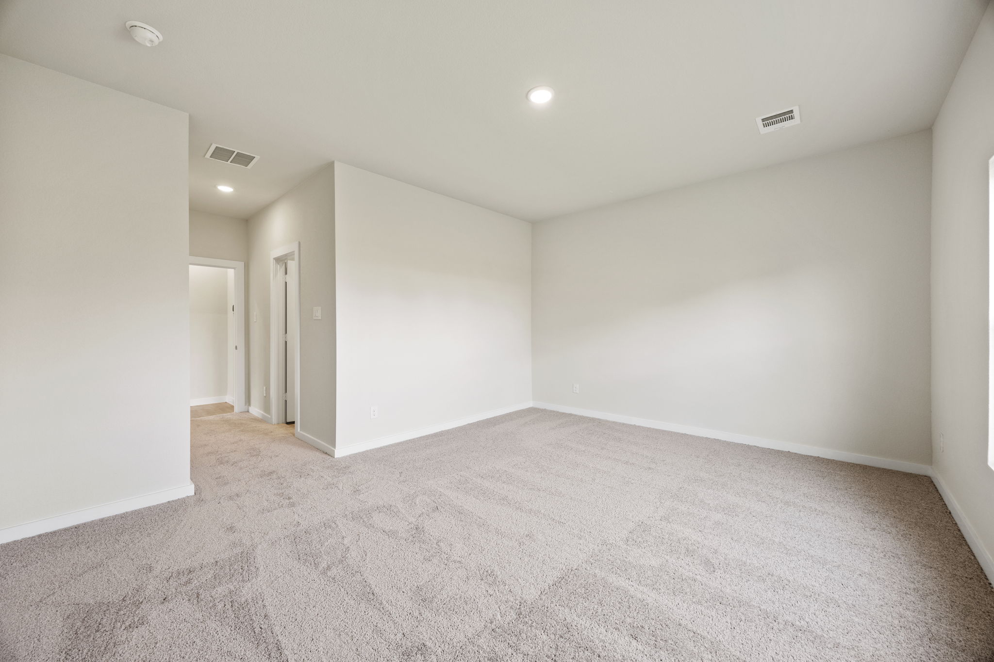 A long hallway with white walls.