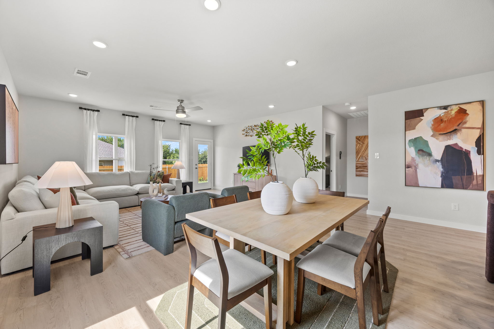 A living room with a table and chairs.