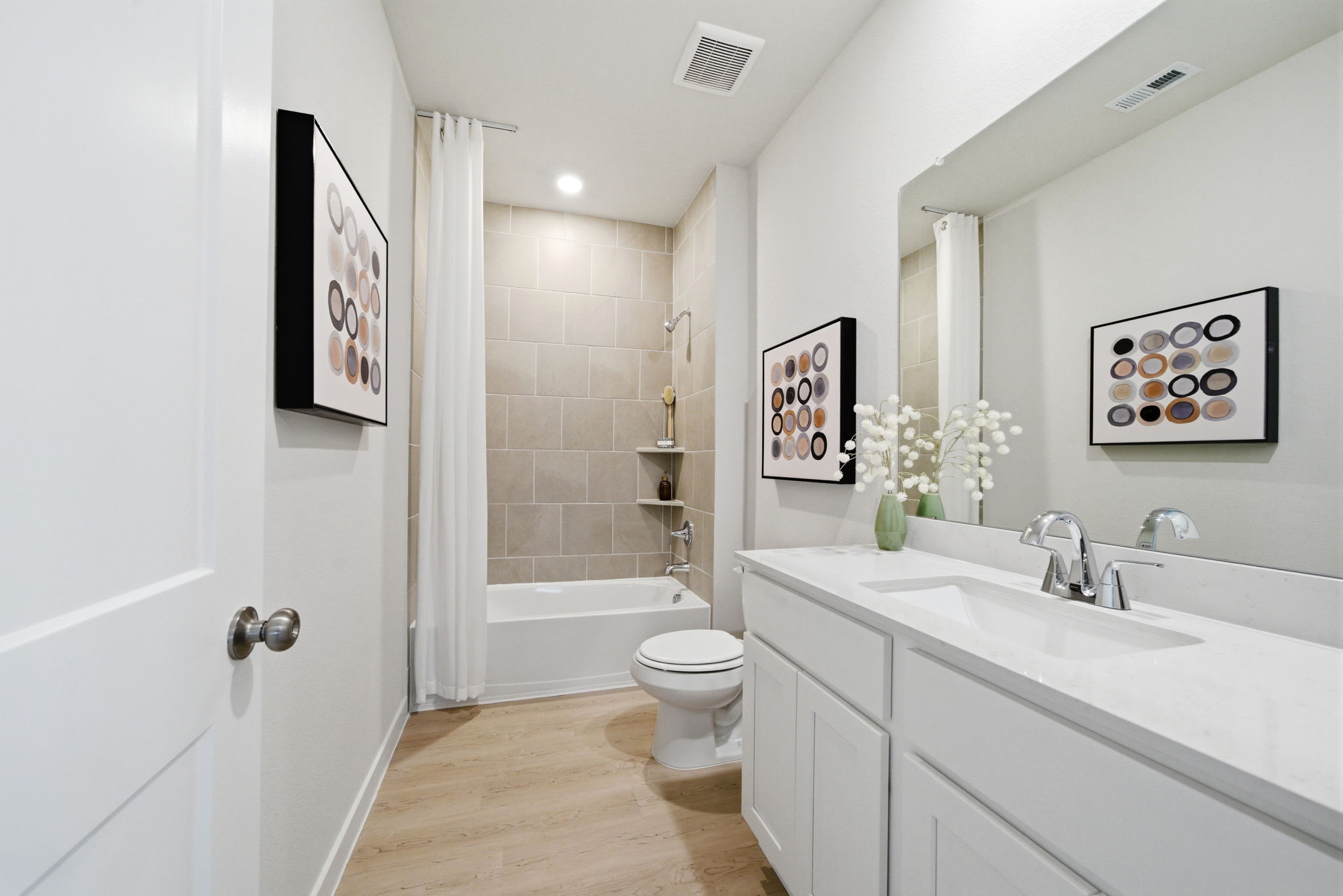 A bathroom with a tub sink and toilet.