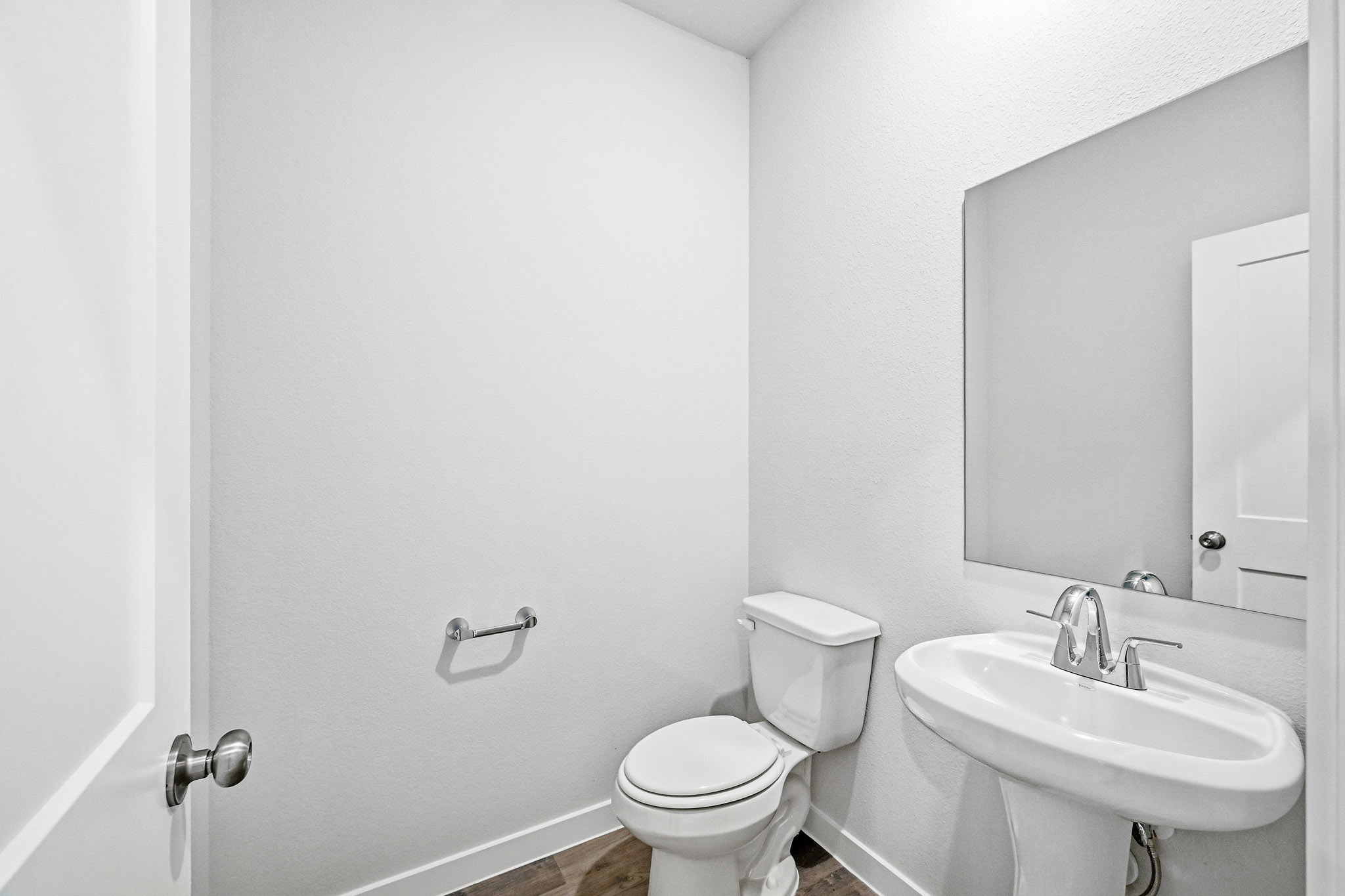 A bathroom with a toilet and sink.