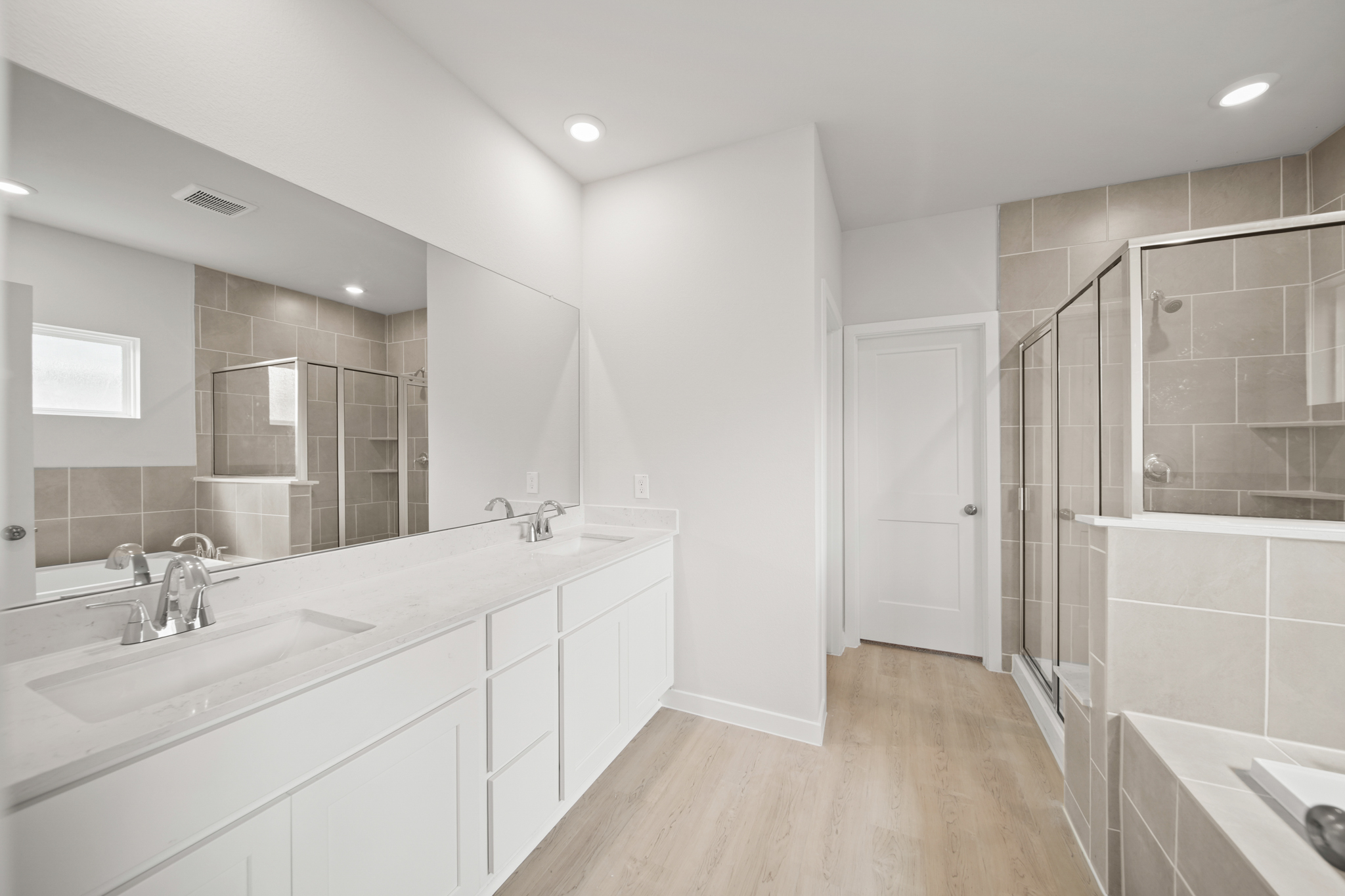 A bathroom with a large mirror.