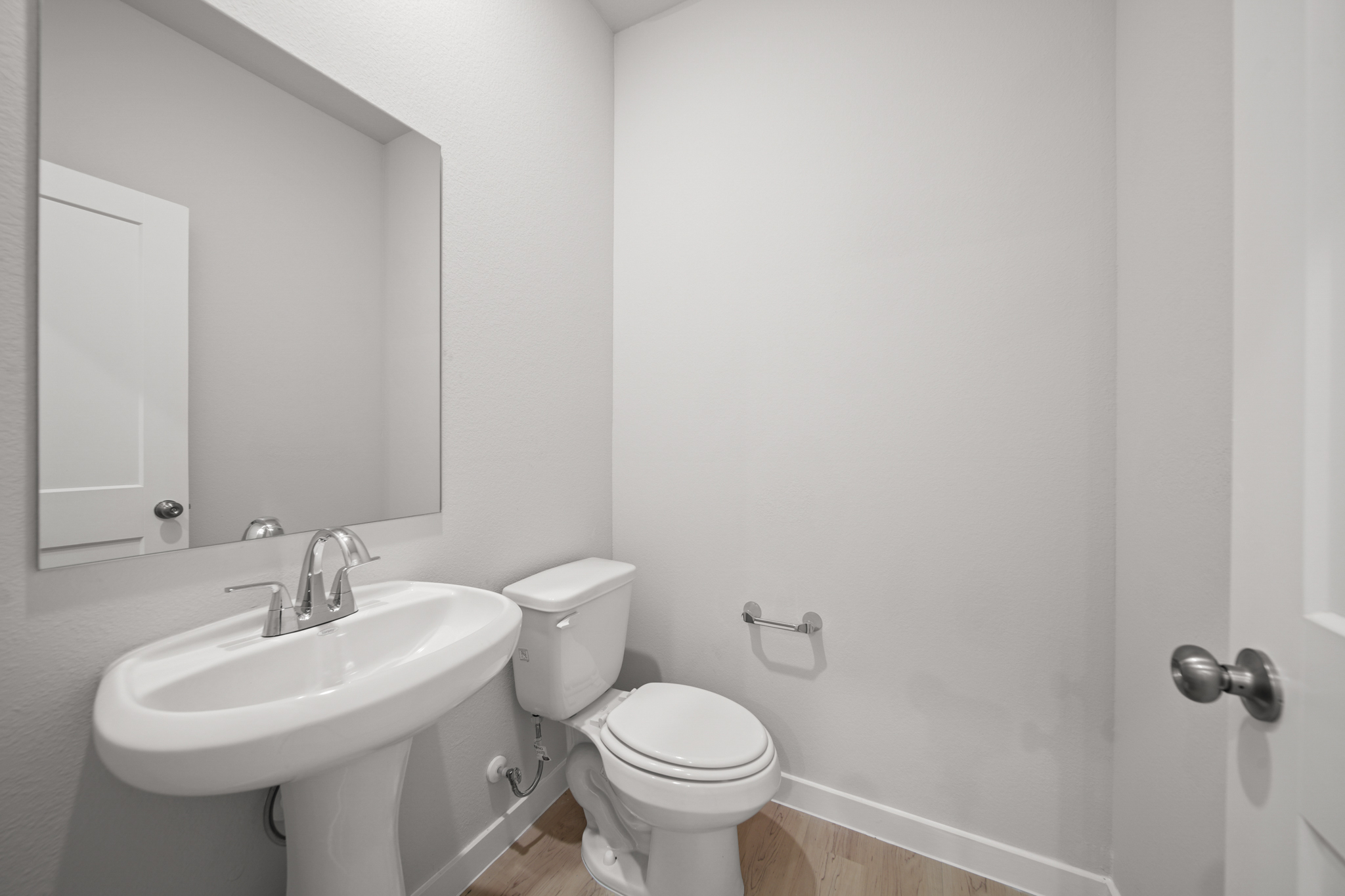 A bathroom with a toilet and sink.