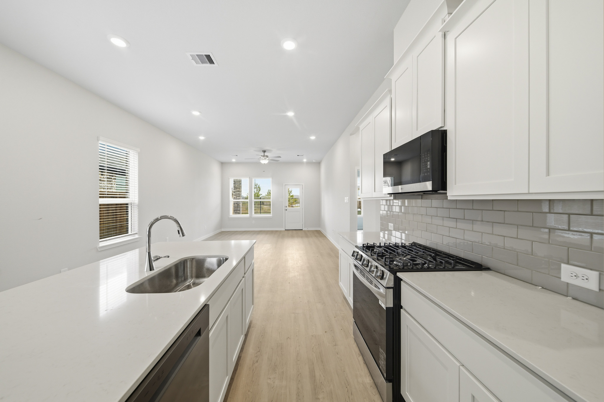A kitchen with white cabinets.