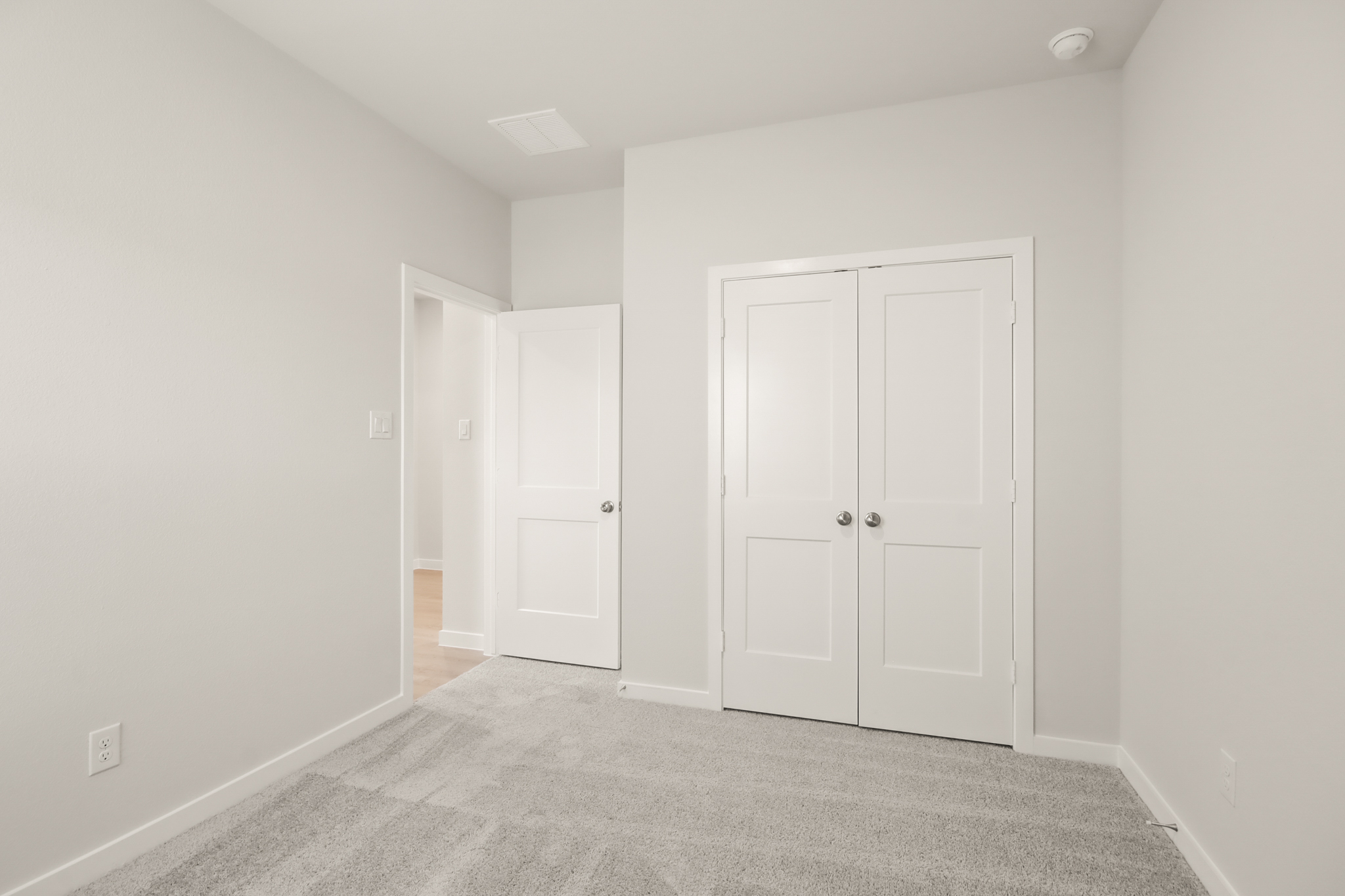 A hallway with white doors.