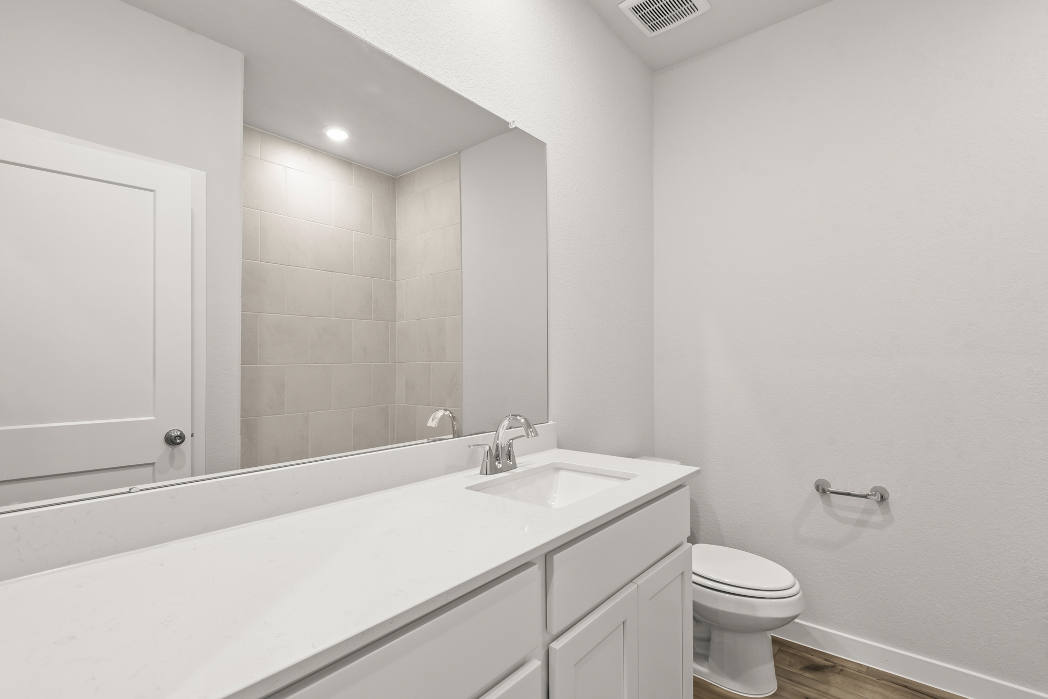 A bathroom with a tub sink and toilet.