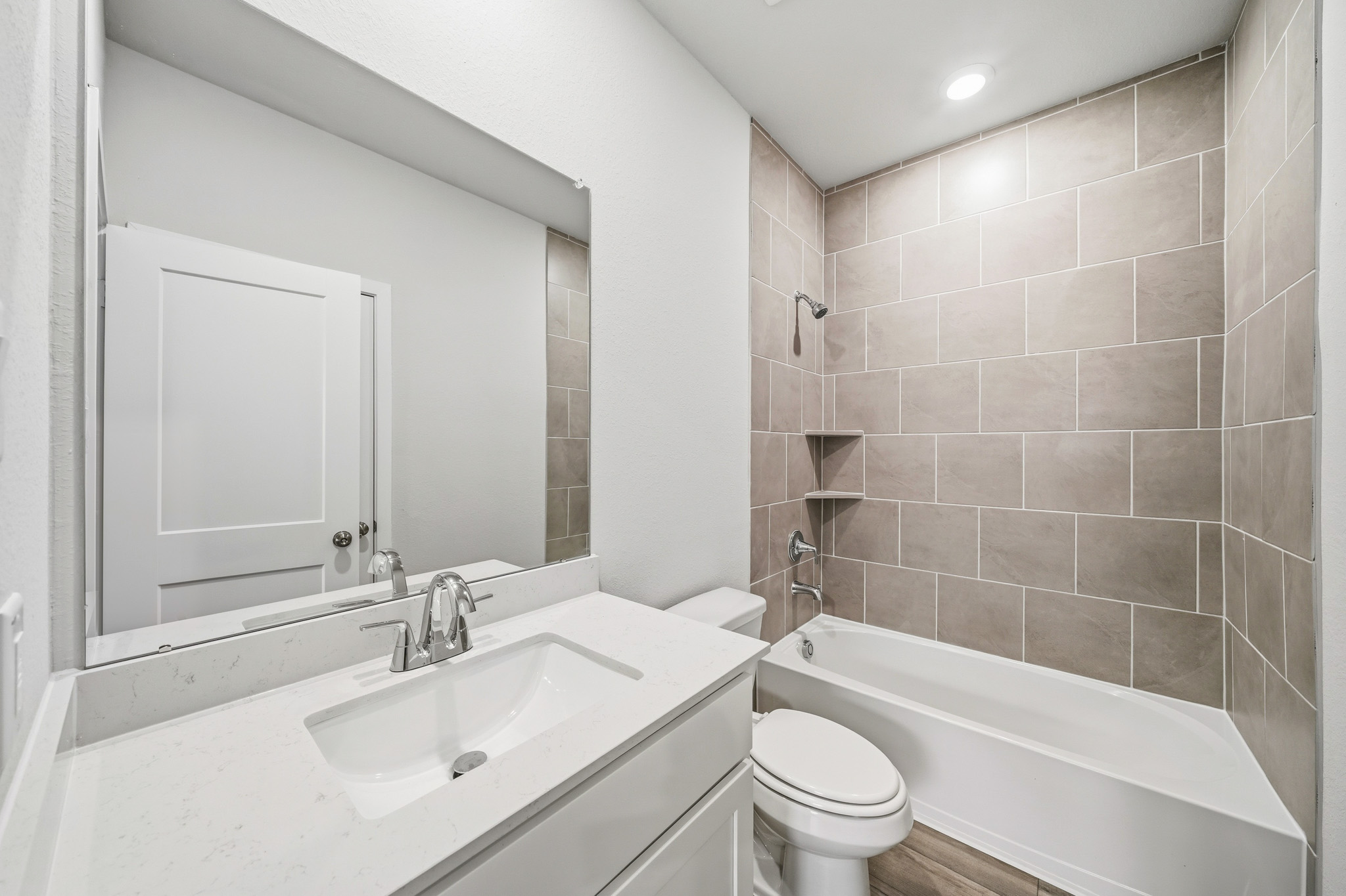 A bathroom with a tub sink and toilet.