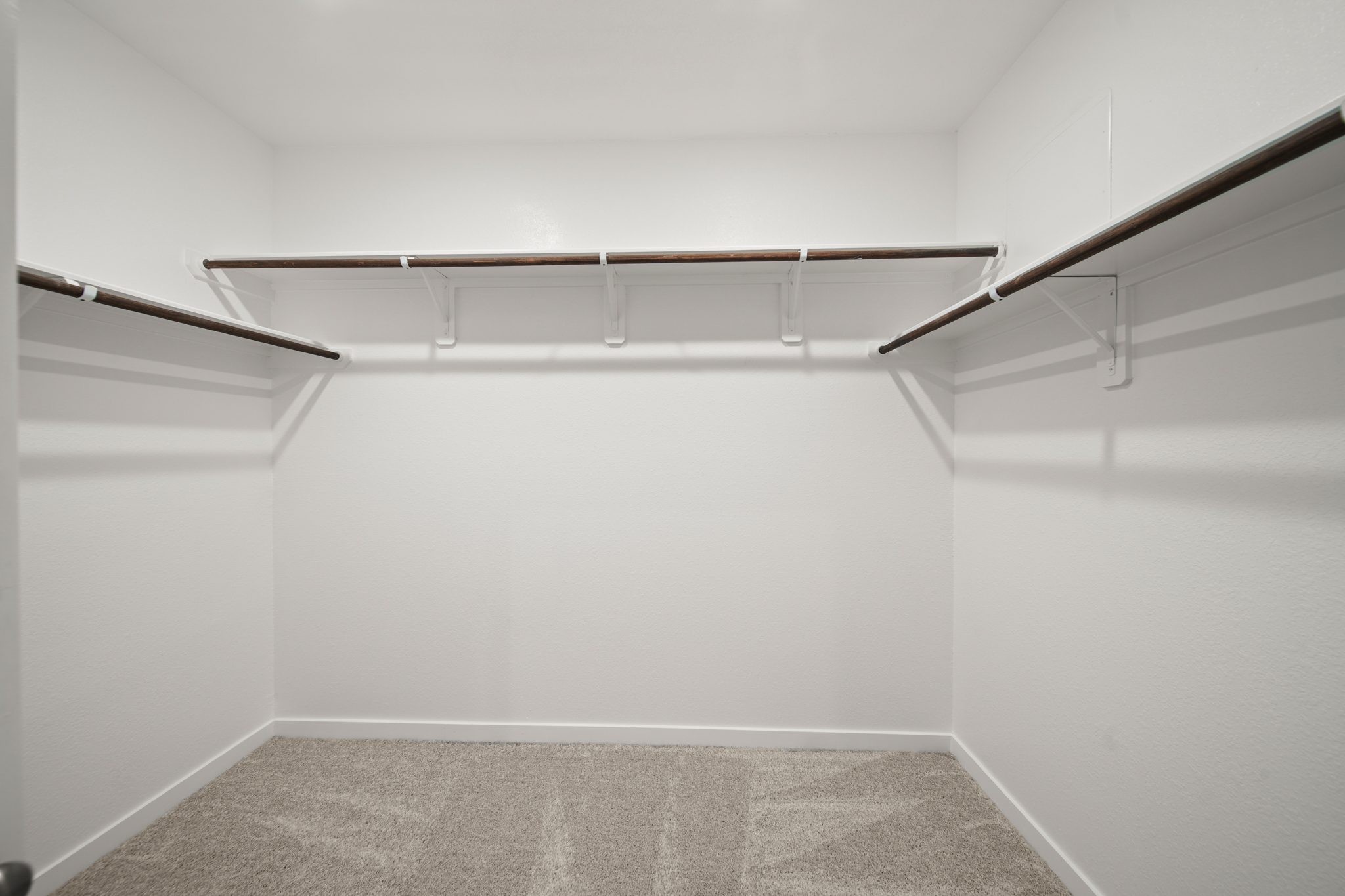 A white room with a carpet.