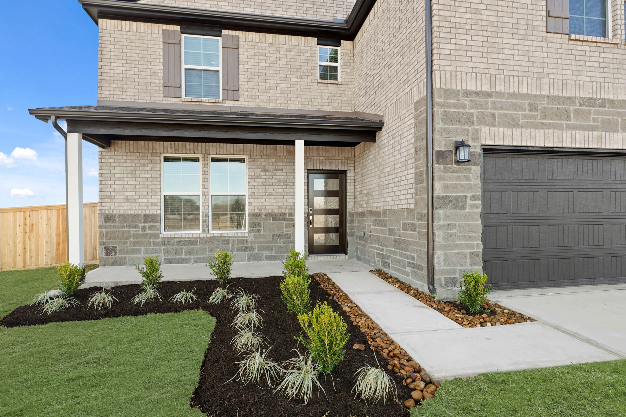 A house with a garage and a lawn.