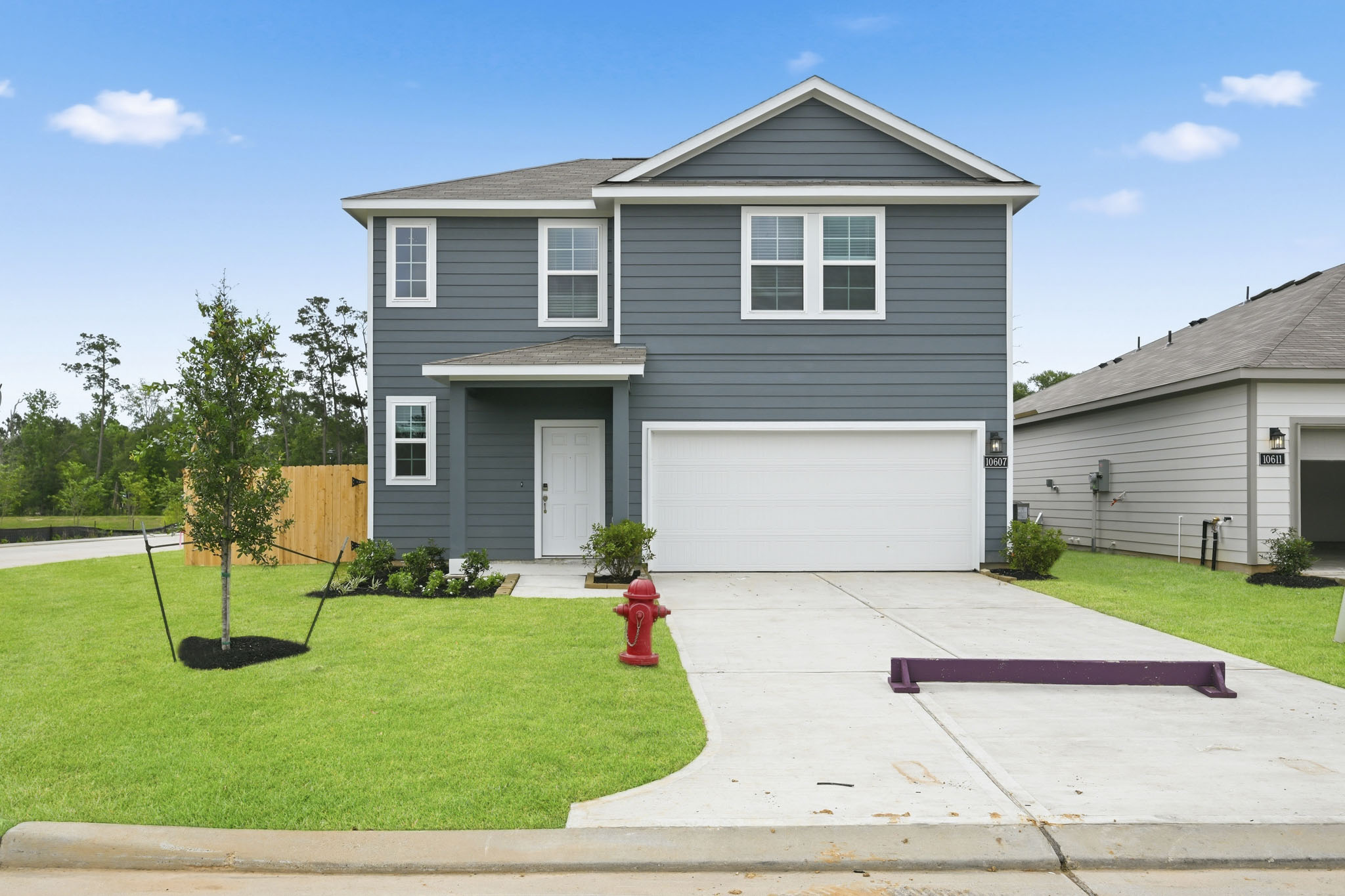 A house with a red fire hydrant in the front.