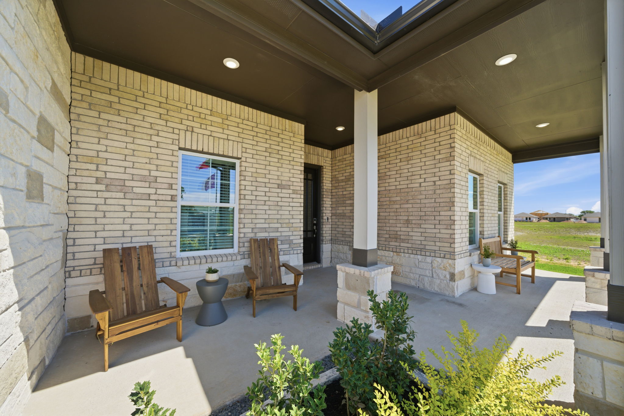 A brick building with benches and a large window.