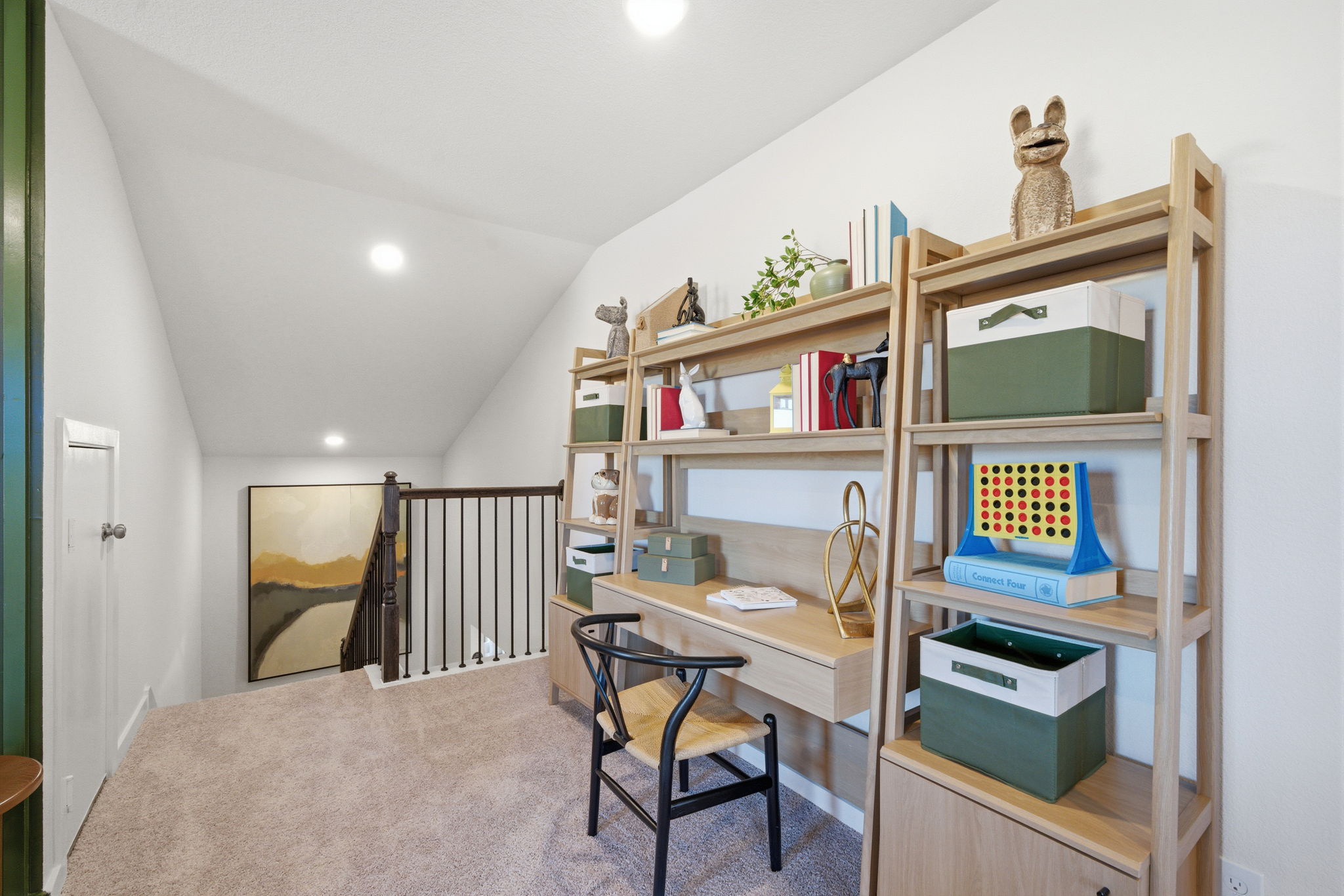 A room with a desk and shelves.